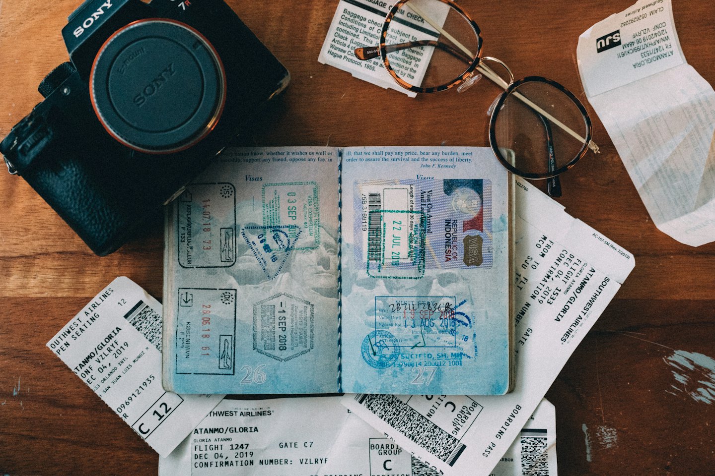 Travel essentials like passports and boarding passes on a wooden table.